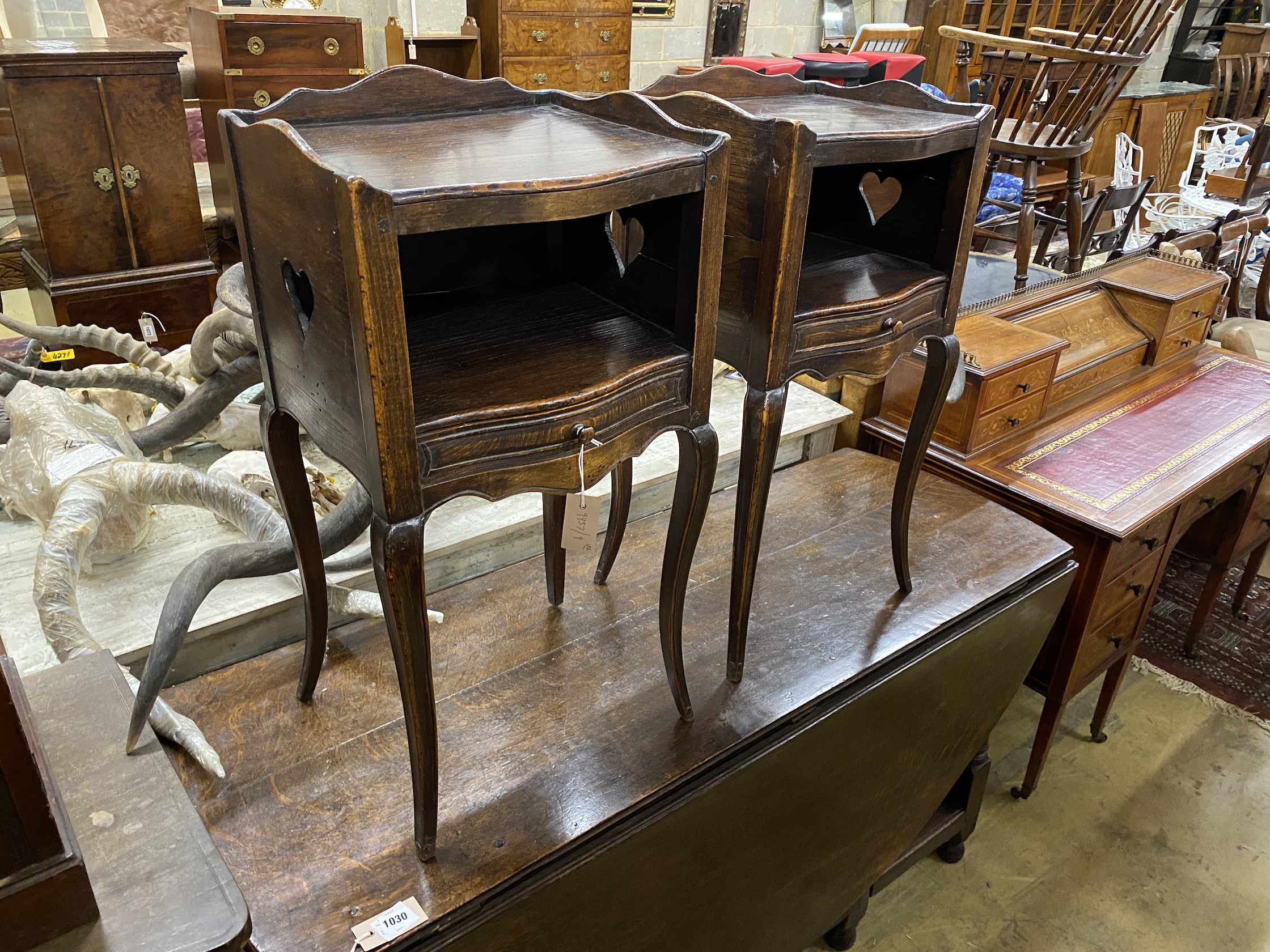 A pair of French elm and beech serpentine bedside cabinets, width 39cm, depth 34cm, height 78cm